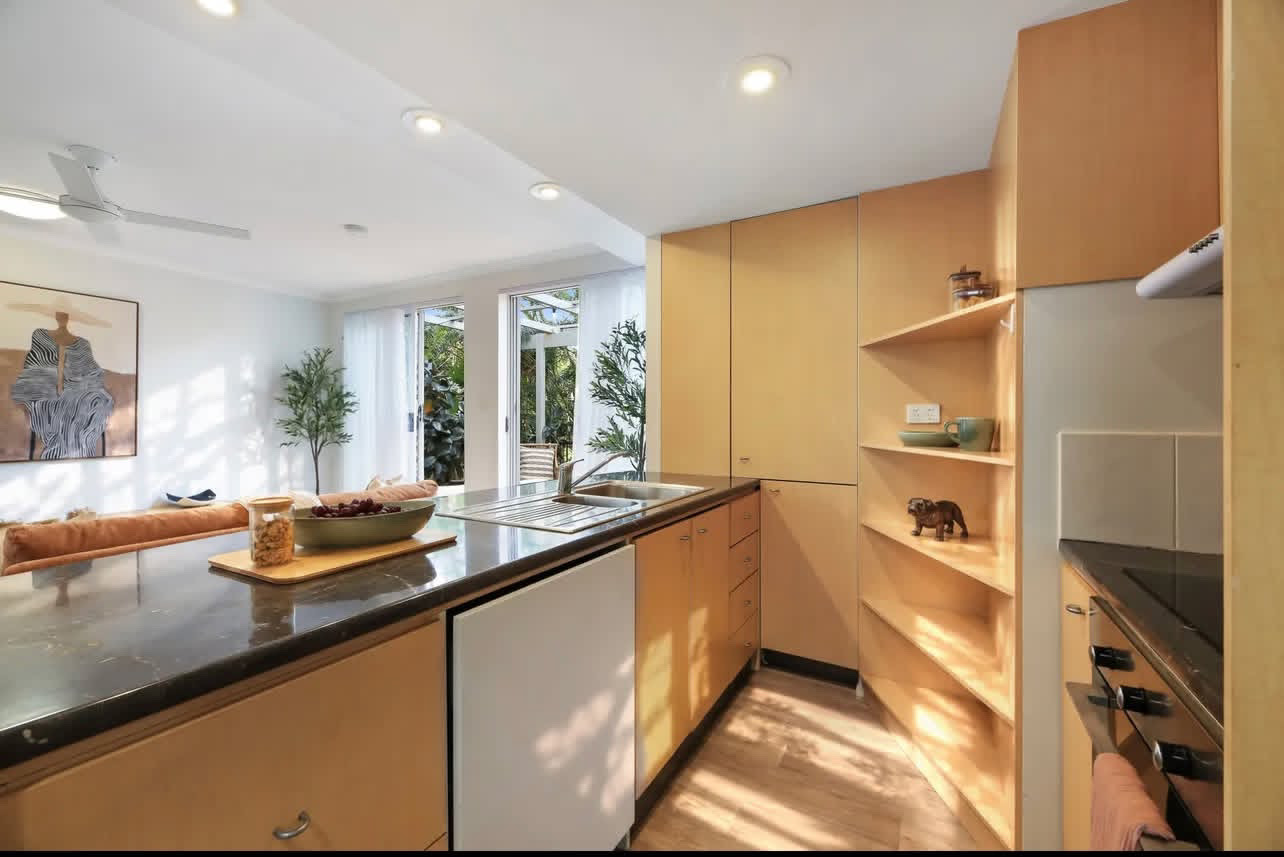 Timber kitchen styled with ceramics and greenery