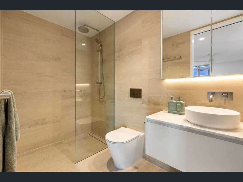 Travertine bathroom with walk-in shower and vessel basin