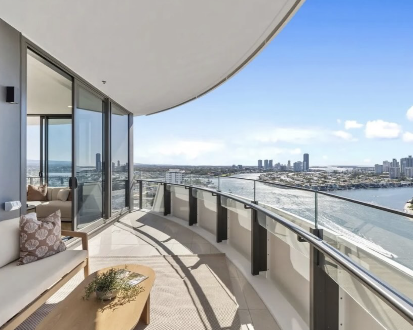 Curved glass balcony with river and city views