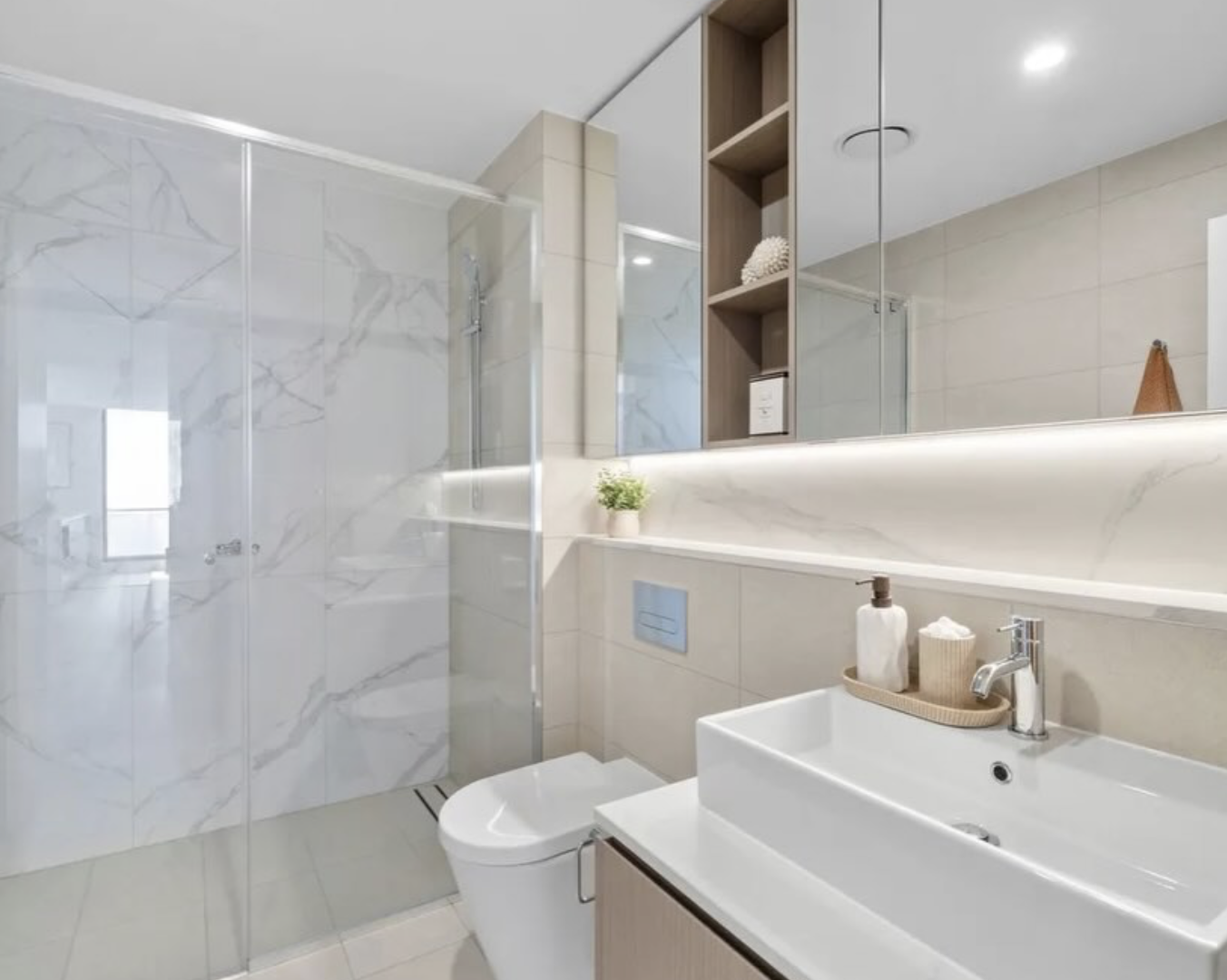 Ensuite styled with oak vanity and soft linens