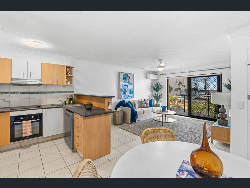 Open-plan kitchen, dining and living zones styled in coastal neutrals