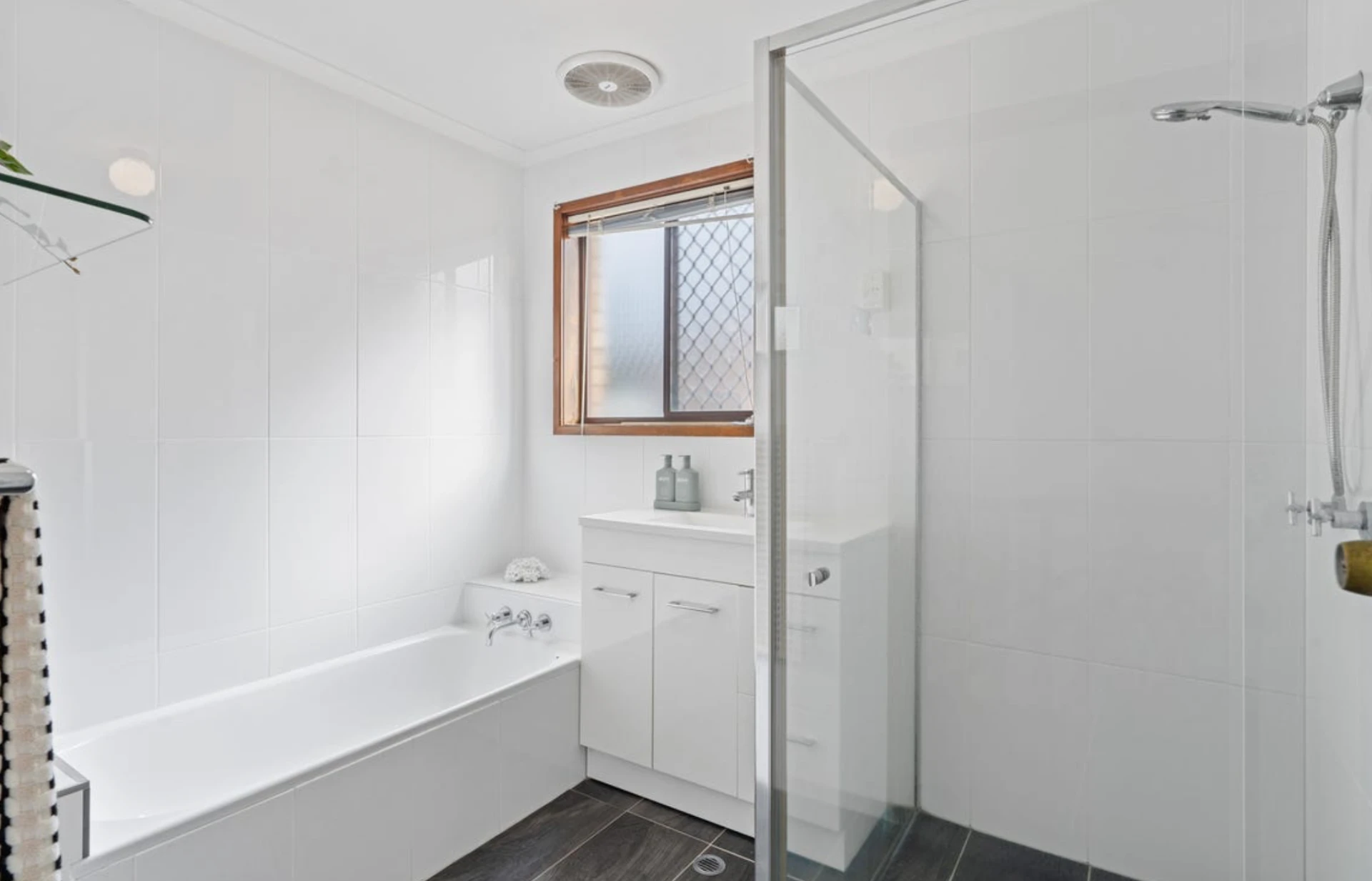 White bathroom with bath, shower and styled vanity