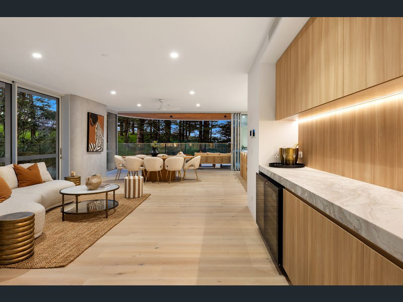 Living and dining zone with marble bar, oak cabinetry and Norfolk pine outlook