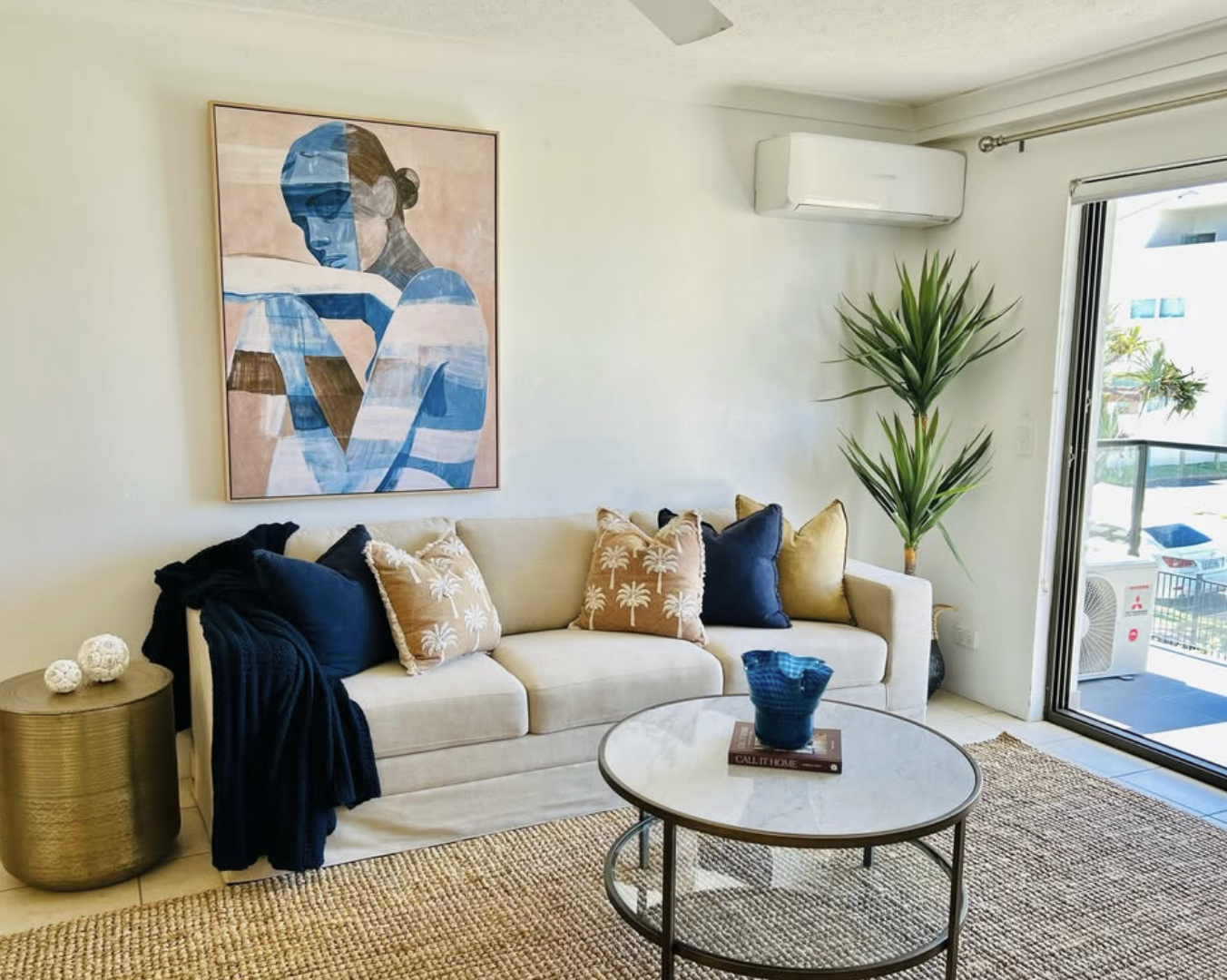 Living room styled with a neutral sofa and layered coastal textures